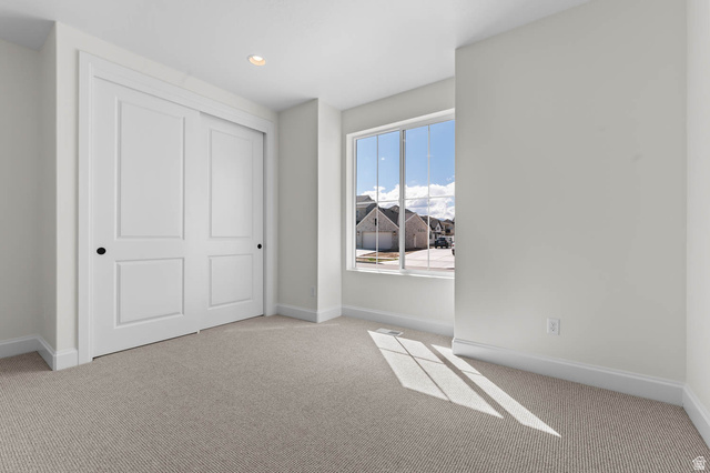 11749 South Halls Crk Road Draper, UT 84020 - Photo 8 of 21 Unfurnished bedroom featuring light colored carpet, a closet, and recessed lighting