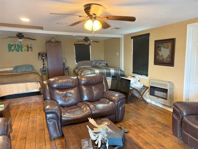 a view of a balcony with chairs and wooden floor