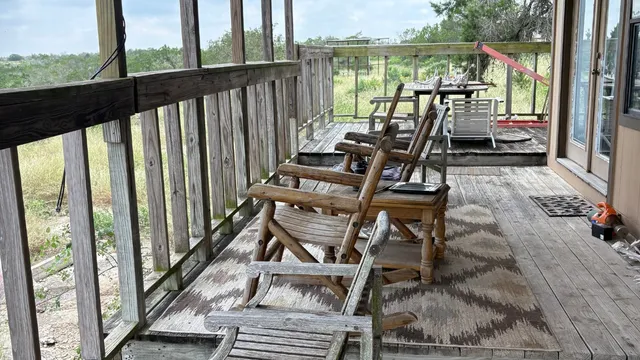 a front view of house with yard and trees around
