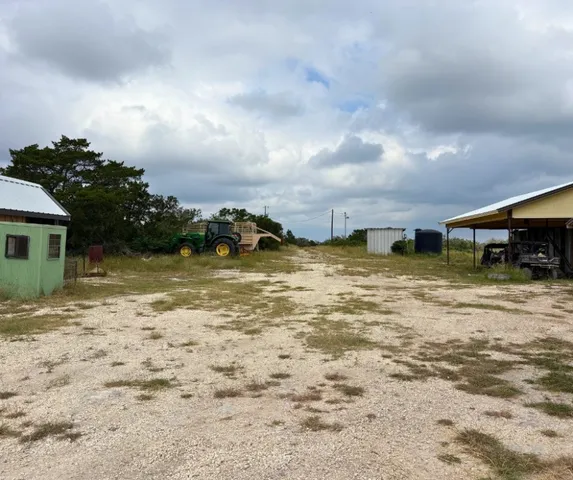 a view of a field of grass and trees
