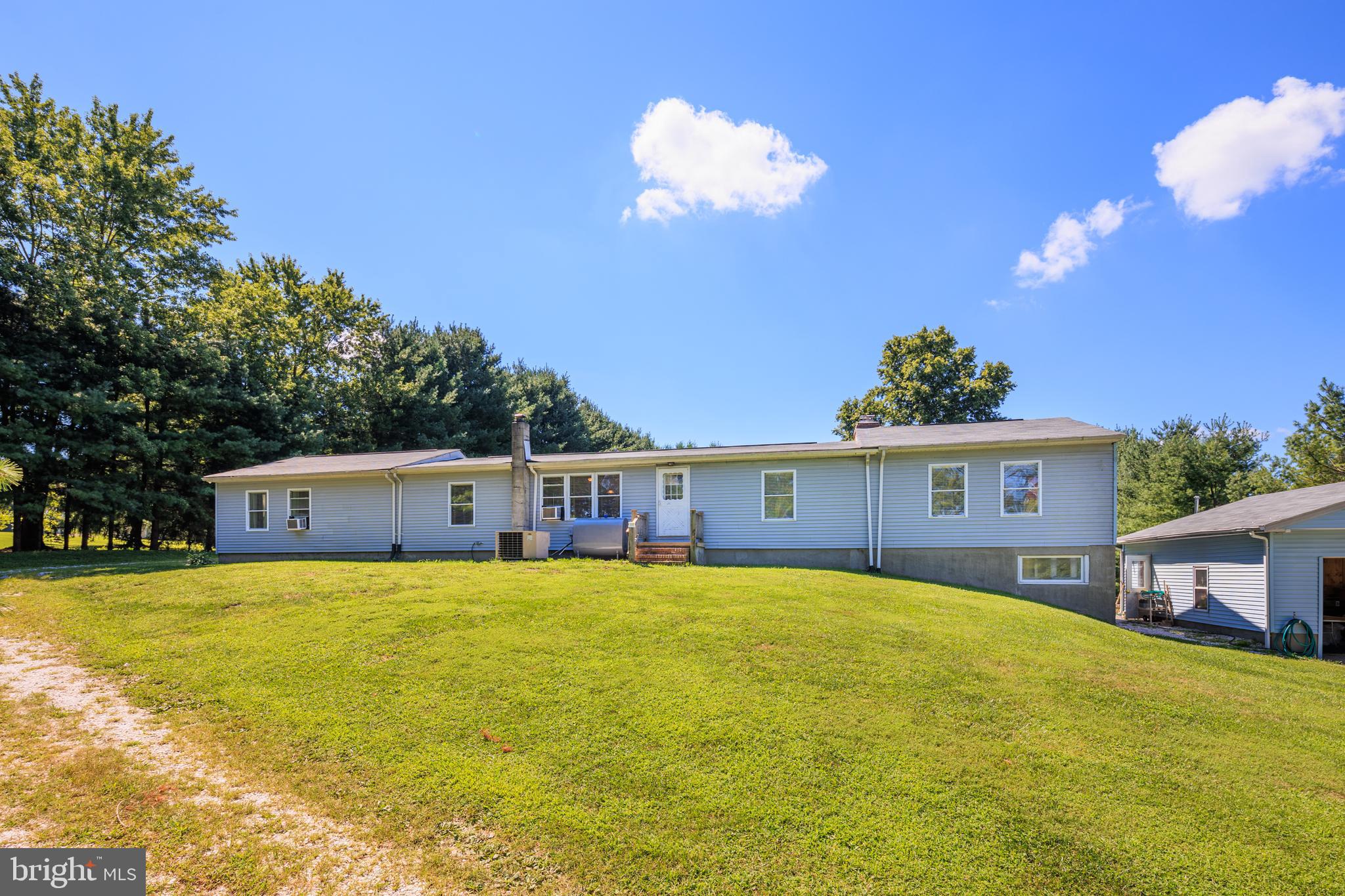 a view of a house with a yard and potted plants
