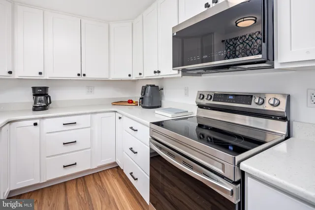 a kitchen with cabinets and appliances