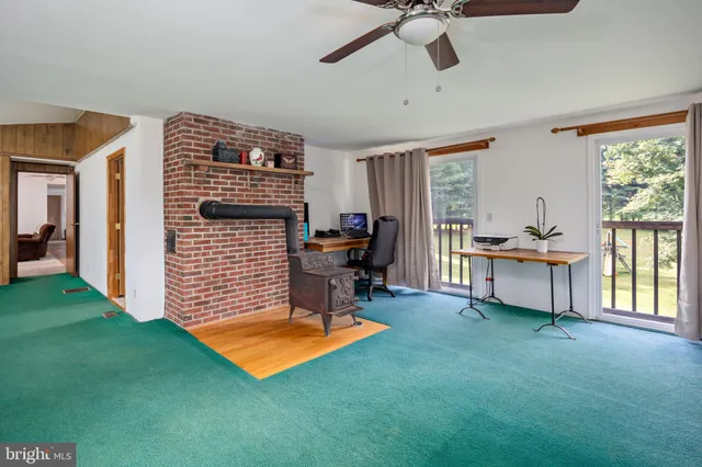 a living room with furniture and a open kitchen area