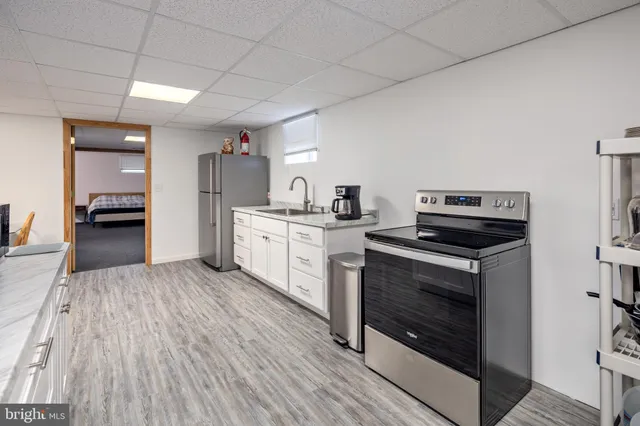 a kitchen with a stove oven and sink