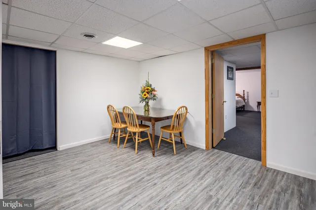 a dining room with furniture and wooden floor