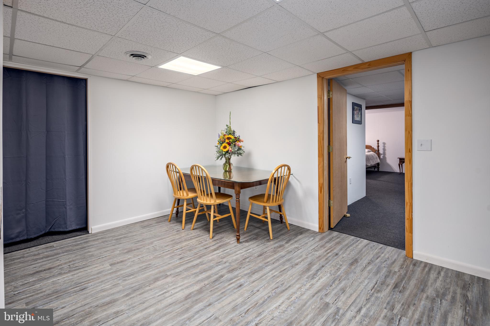 1045 Doyle Road Street, MD 21154 - Photo 31 of 49 a dining room with furniture and wooden floor