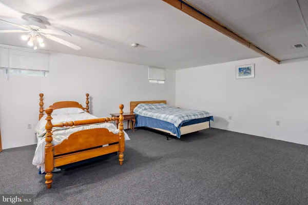 a bedroom with two beds and a chandelier