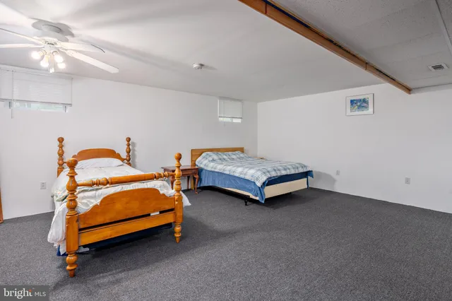 a bedroom with two beds and a chandelier
