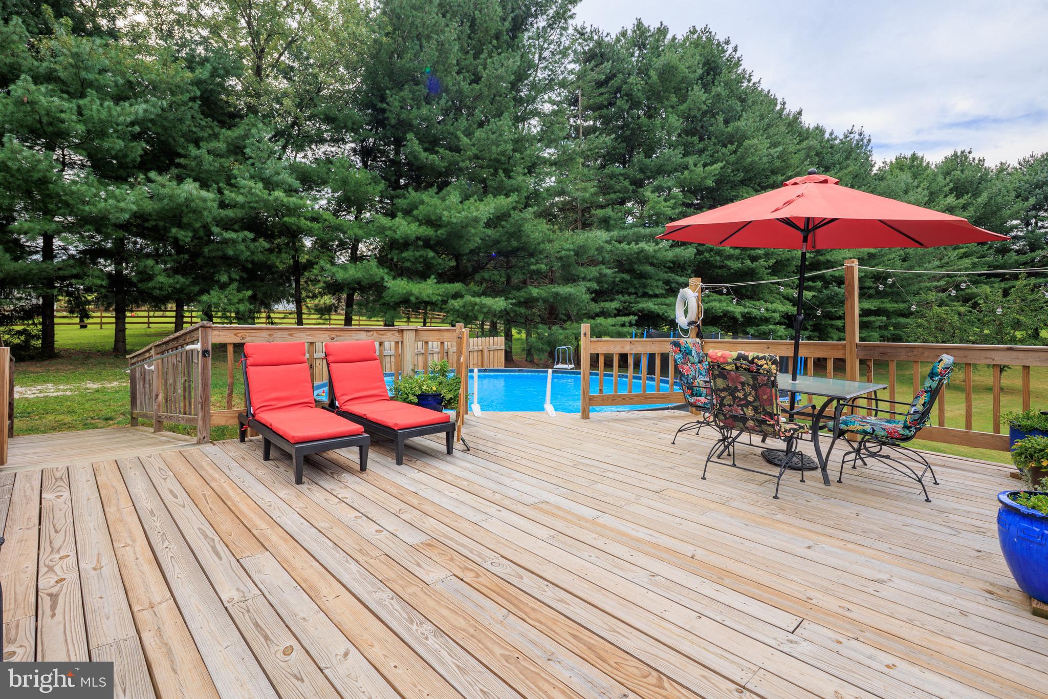 1045 Doyle Road Street, MD 21154 - Photo 34 of 47 an outdoor sitting area with furniture and umbrella