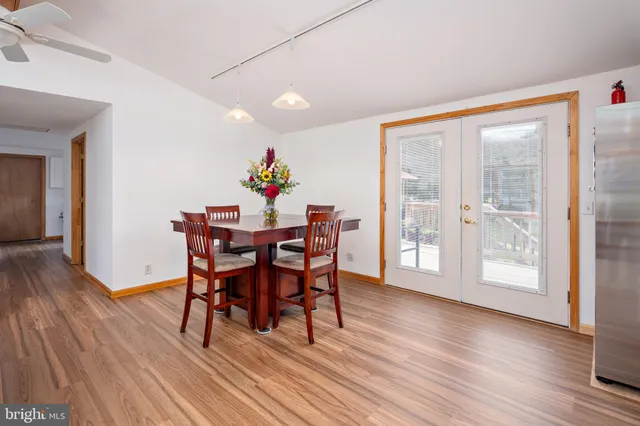 a view of a dining room with furniture and wooden floor