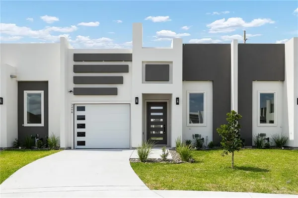 a front view of a house with a yard and garage