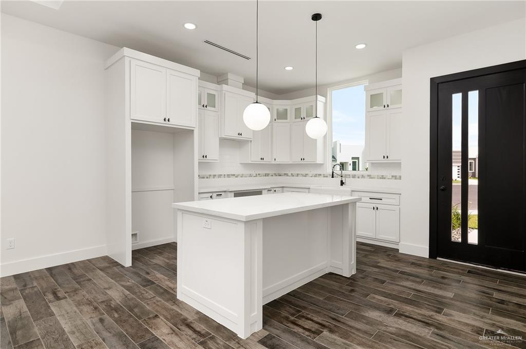 3309 South Marla Court Edinburg, TX 78539 - Photo 3 of 6 a kitchen with a sink a counter space and wooden floor