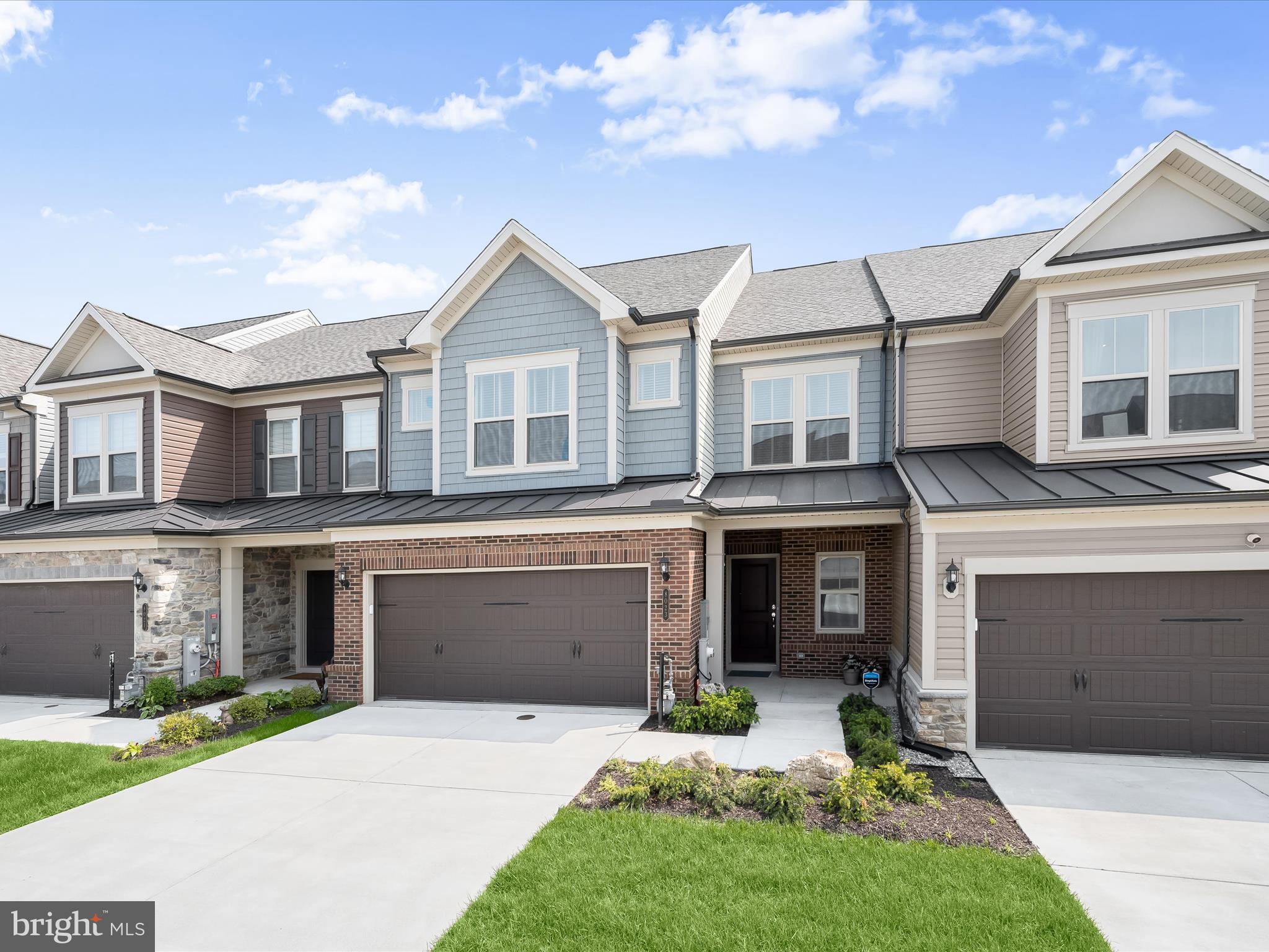 8023 Jennys Way, Unit 9 Fulton, MD 20759 - Photo 1 of 46 a front view of a house with a yard and garage