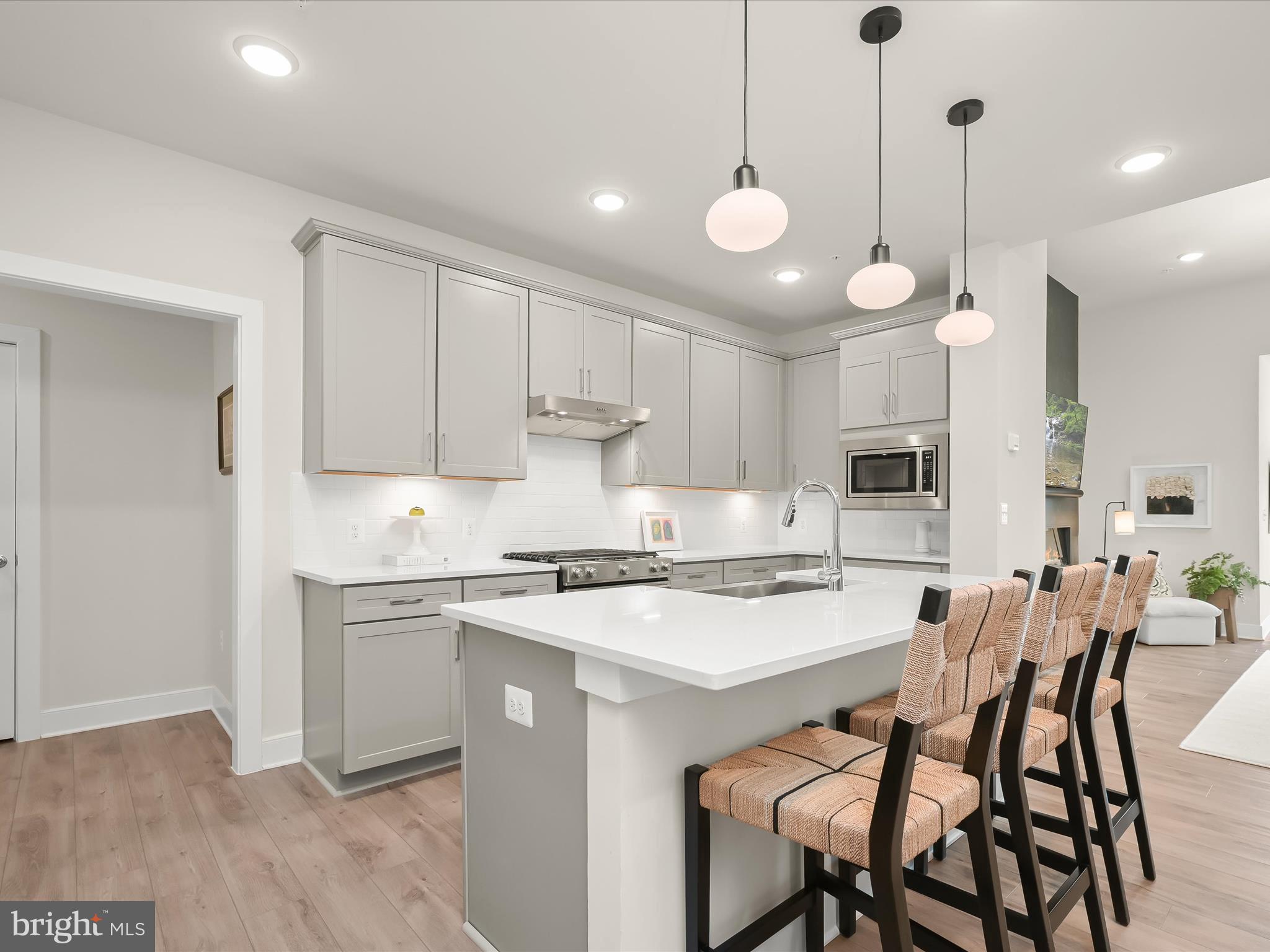 8023 Jennys Way, Unit 9 Fulton, MD 20759 - Photo 15 of 46 a kitchen with stainless steel appliances granite countertop a sink a stove a refrigerator and white cabinets with wooden floor