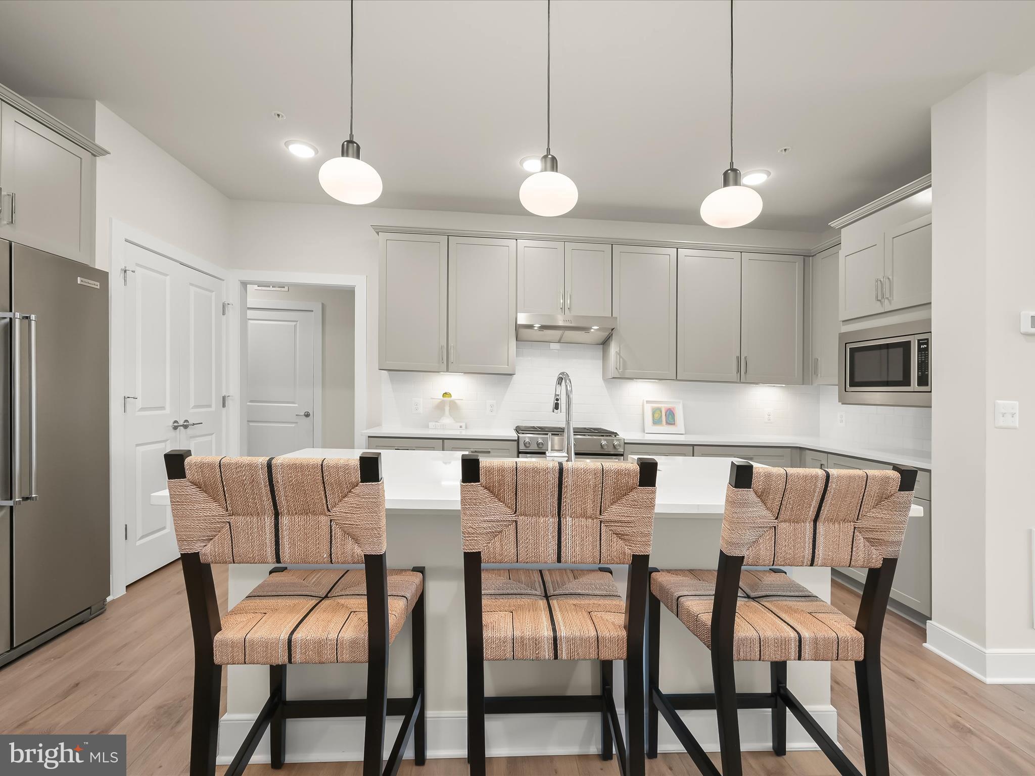 8023 Jennys Way, Unit 9 Fulton, MD 20759 - Photo 20 of 46 a view of kitchen with cabinets and wooden floor