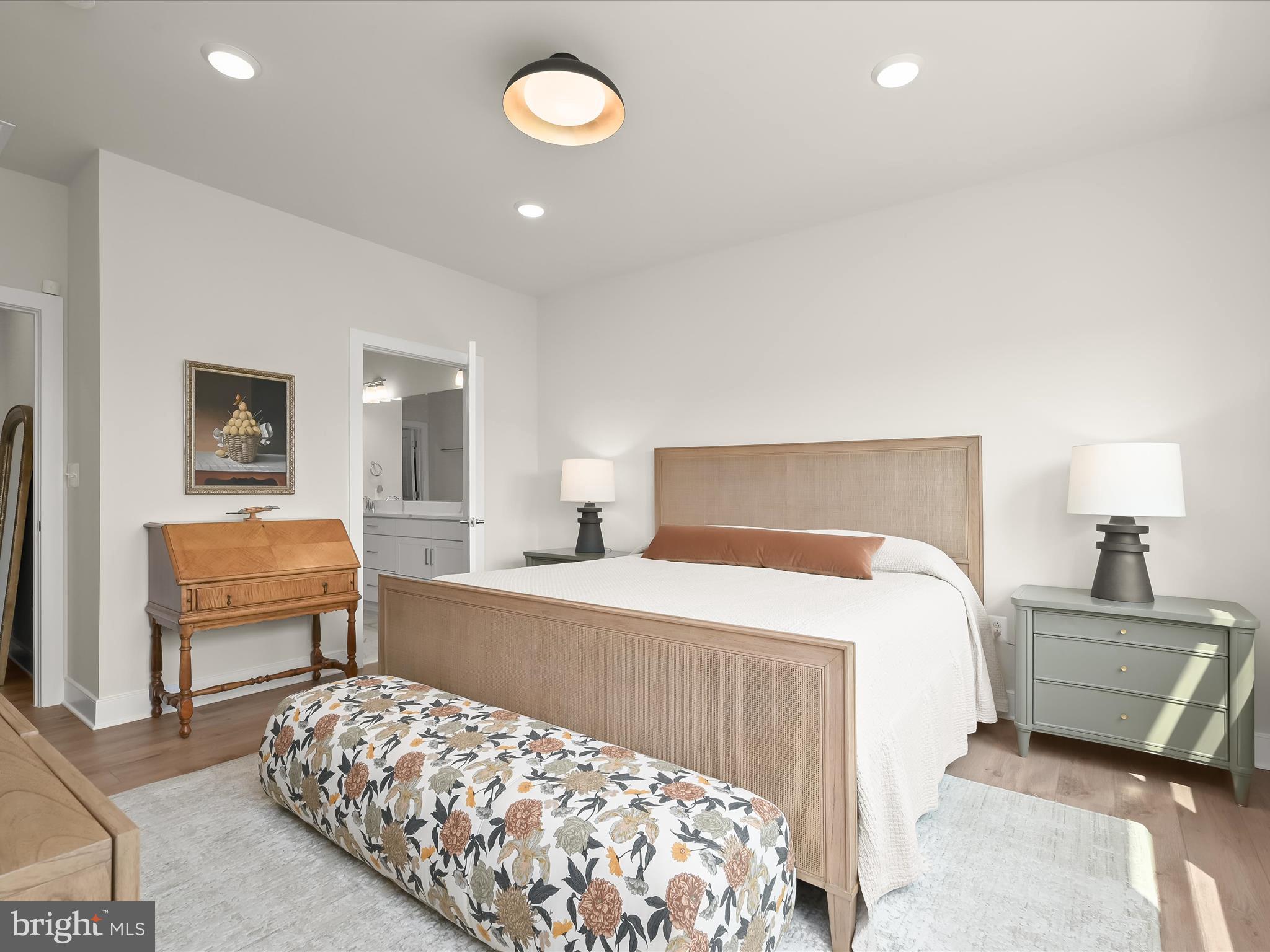 8023 Jennys Way, Unit 9 Fulton, MD 20759 - Photo 23 of 46 a bedroom with a bed and wooden floor