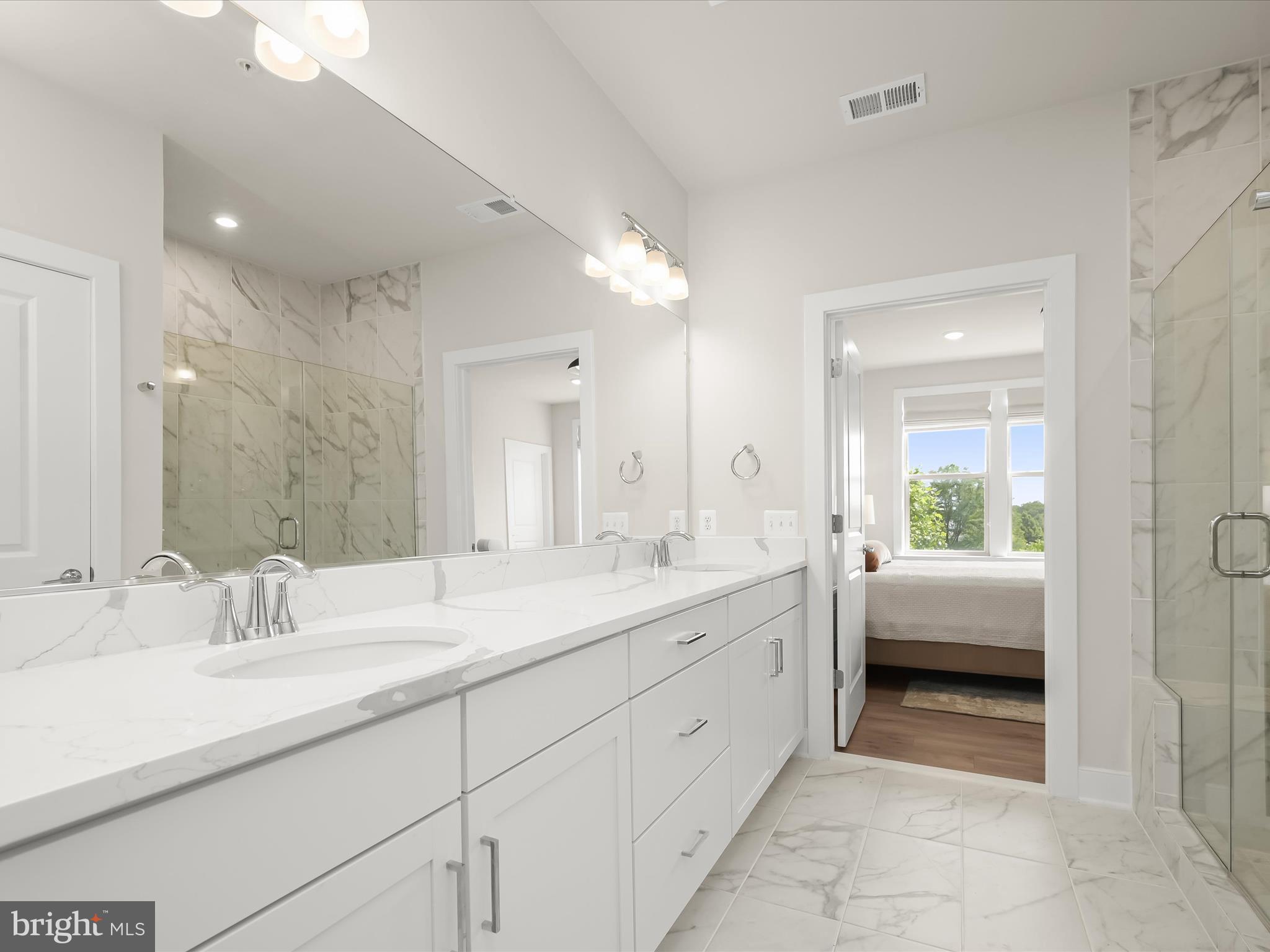 8023 Jennys Way, Unit 9 Fulton, MD 20759 - Photo 26 of 46 a spacious bathroom with a double vanity sink mirror and next to a window