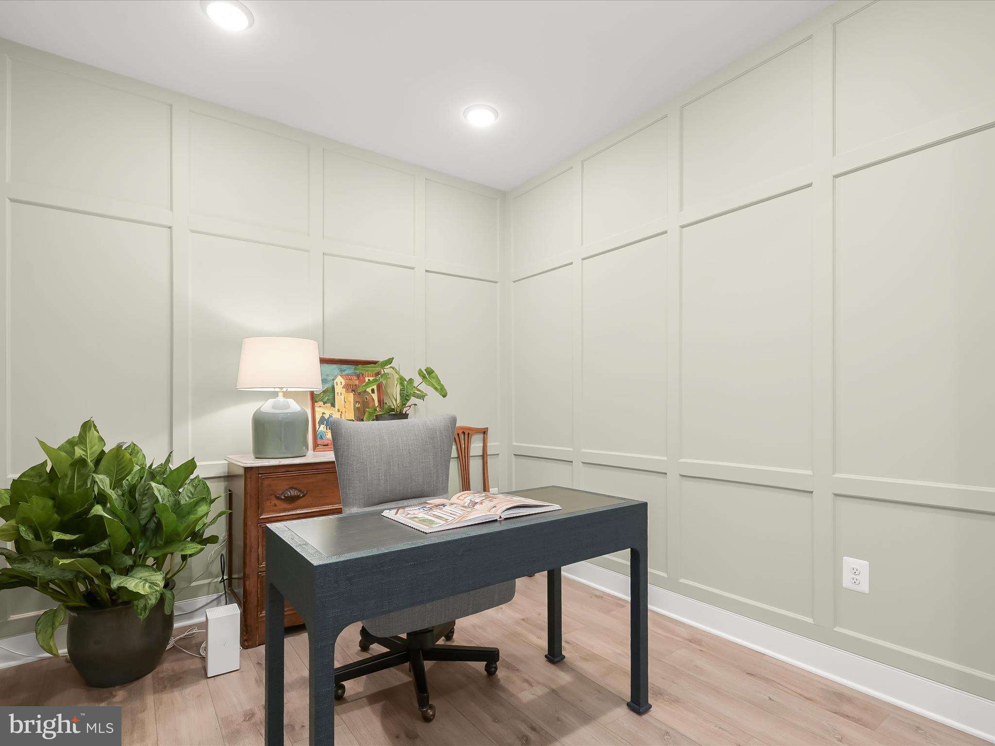 8023 Jennys Way, Unit 9 Fulton, MD 20759 - Photo 27 of 46 a view of a workspace with a table and chair in wooden floor