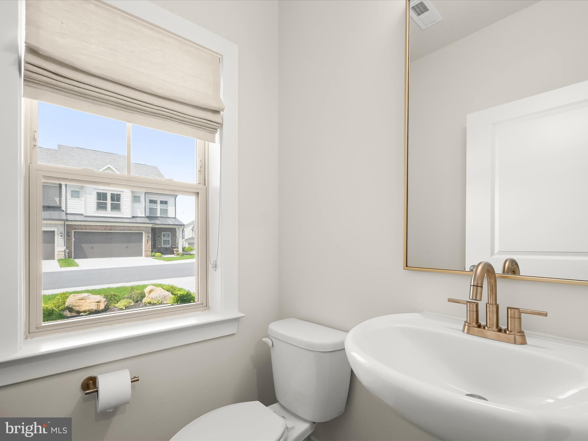 8023 Jennys Way, Unit 9 Fulton, MD 20759 - Photo 30 of 46 a bathroom with a toilet sink and a window
