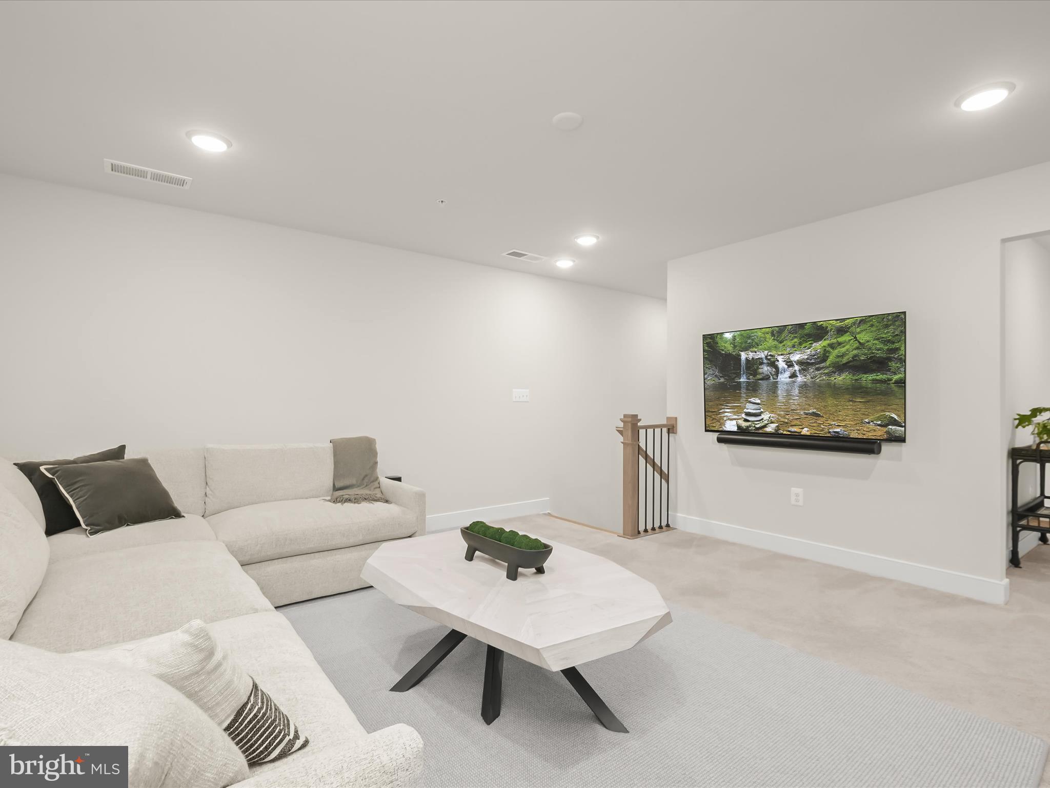 8023 Jennys Way, Unit 9 Fulton, MD 20759 - Photo 34 of 46 a living room with furniture and a flat screen tv