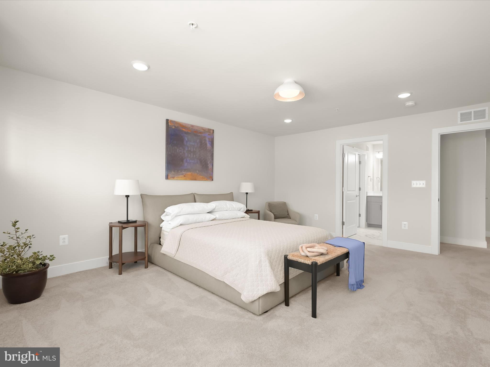 8023 Jennys Way, Unit 9 Fulton, MD 20759 - Photo 36 of 46 a bedroom with a bed and a potted plant