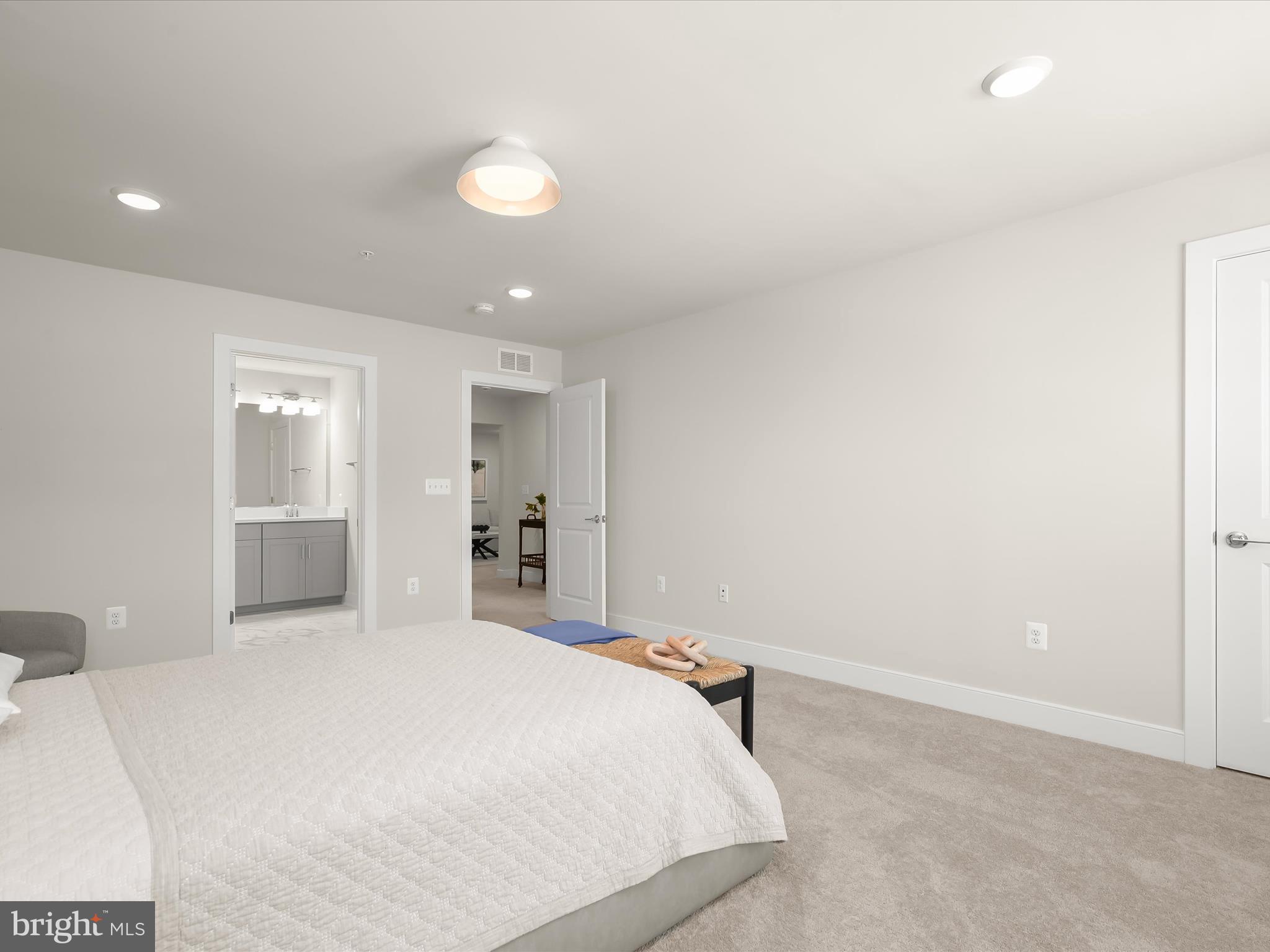 8023 Jennys Way, Unit 9 Fulton, MD 20759 - Photo 37 of 46 a bedroom with a bed and a large mirror