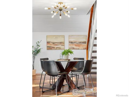 a view of a dining room with furniture and a potted plant