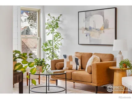 a living room with furniture and a potted plant