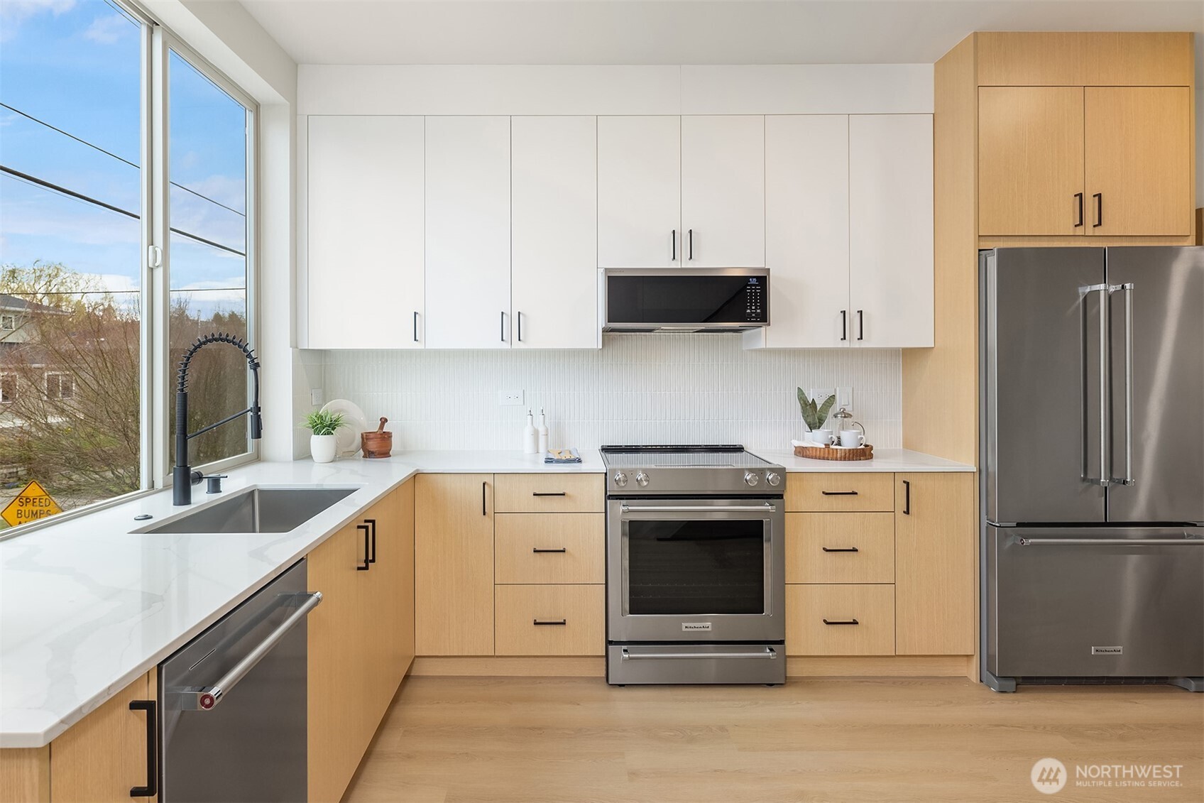 1153 Northwest 58th Street Seattle, WA 98107 - Photo 16 of 29 a kitchen with stainless steel appliances granite countertop a refrigerator sink and stove