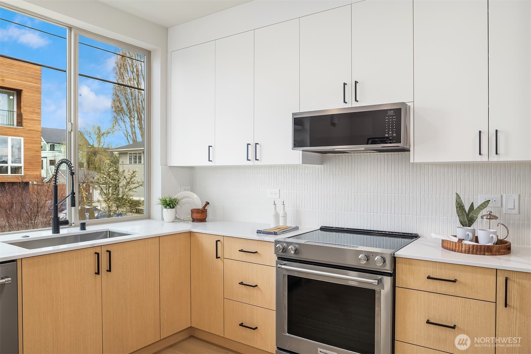 1153 Northwest 58th Street Seattle, WA 98107 - Photo 17 of 29 a kitchen with stainless steel appliances white cabinets and a stove