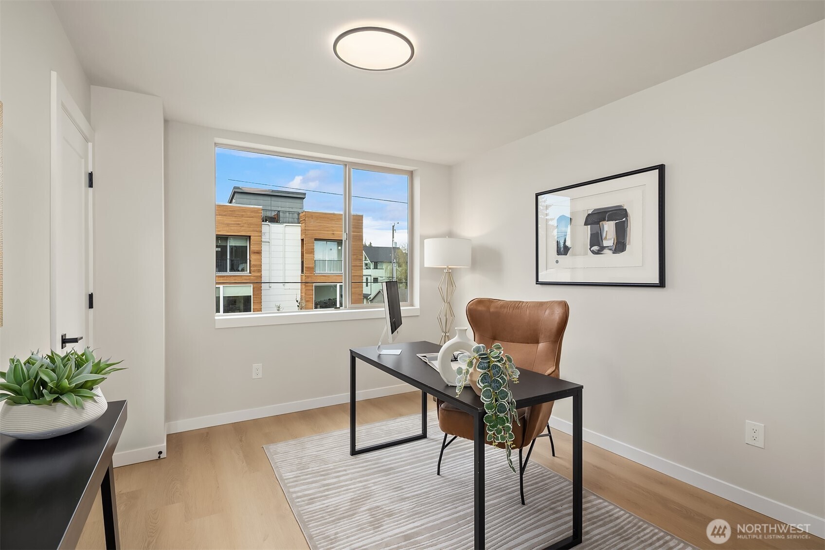 1153 Northwest 58th Street Seattle, WA 98107 - Photo 21 of 29 a workspace with furniture and wooden floor