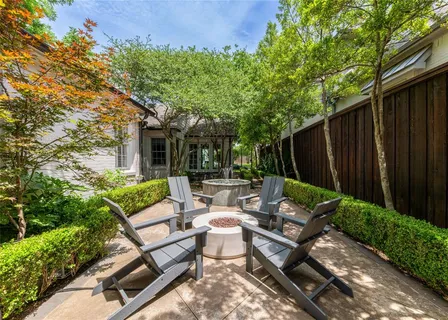 a view of a patio with couches table and chairs and potted plants