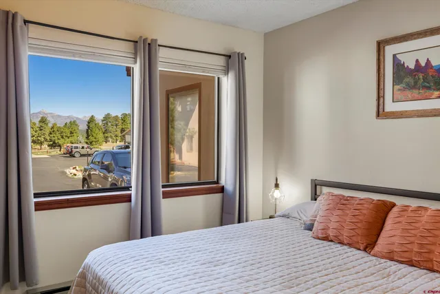 a bedroom with a bed and glass window