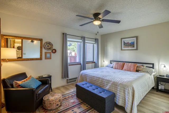 a bedroom with a bed and ceiling fan