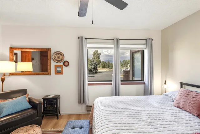 a bedroom with a bed and glass chair