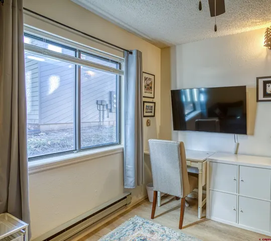 a view of a livingroom with furniture and a flat screen tv