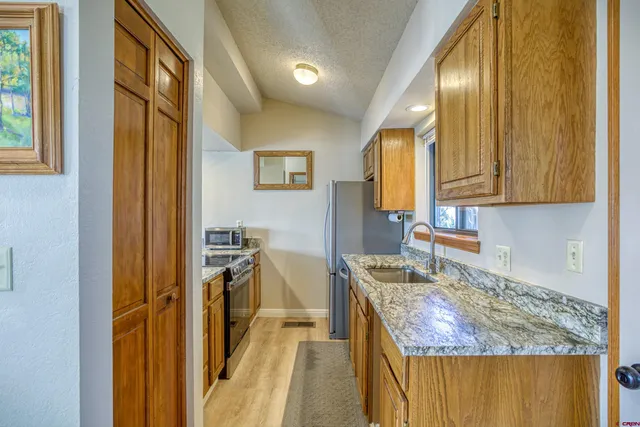 a kitchen with a sink stove and cabinets