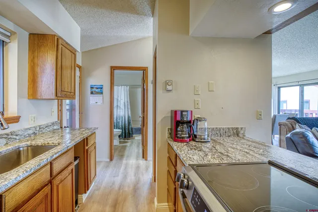 a kitchen with a sink stove and cabinets