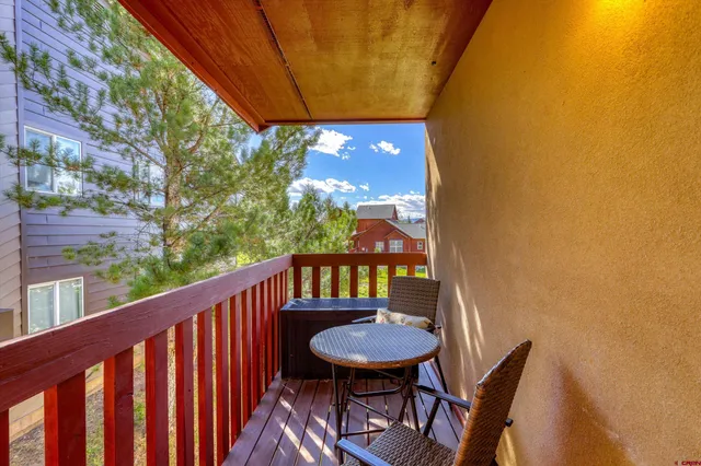 a view of a balcony with furniture