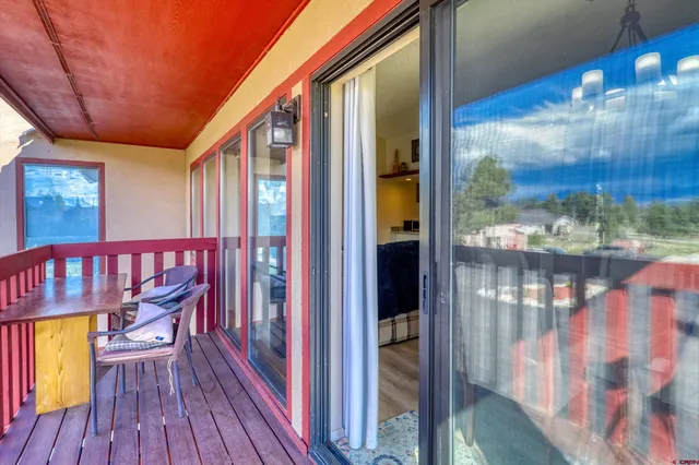 a view of balcony with wooden floor