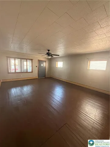 an empty room with a empty space and windows