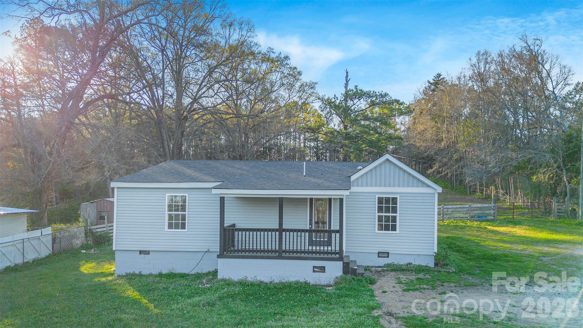 1022 Pine Ridge Road Chester, SC 29706 - Photo 1 of 13 a view of a yard in front of a house with plants and large tree