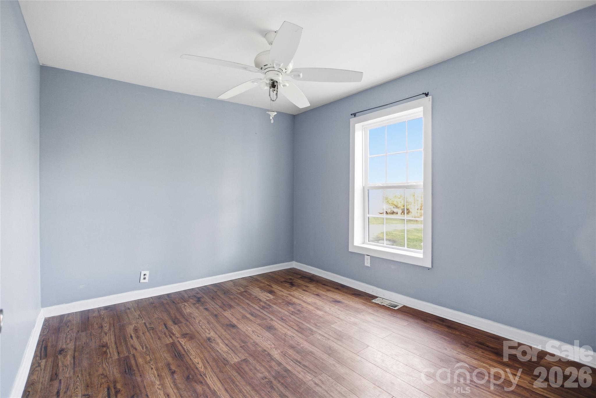 1022 Pine Ridge Road Chester, SC 29706 - Photo 7 of 13 an empty room with a window and wooden floor