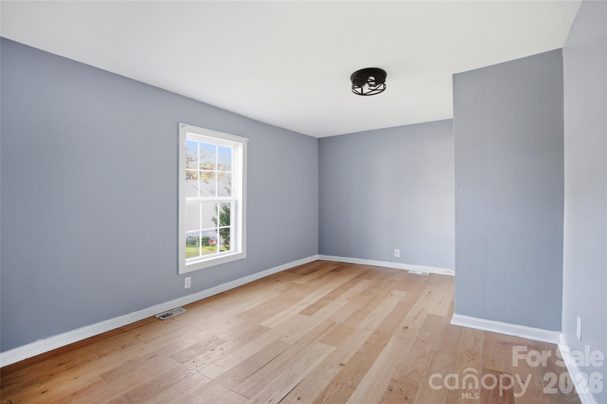 1022 Pine Ridge Road Chester, SC 29706 - Photo 9 of 13 an empty room with wooden floor and windows