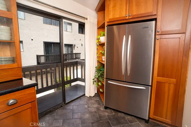a kitchen with stainless steel appliances granite countertop a refrigerator and a stove