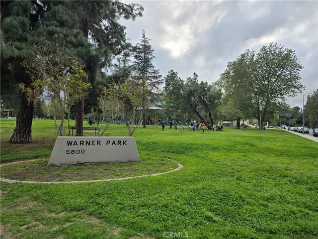a view of a park with large trees