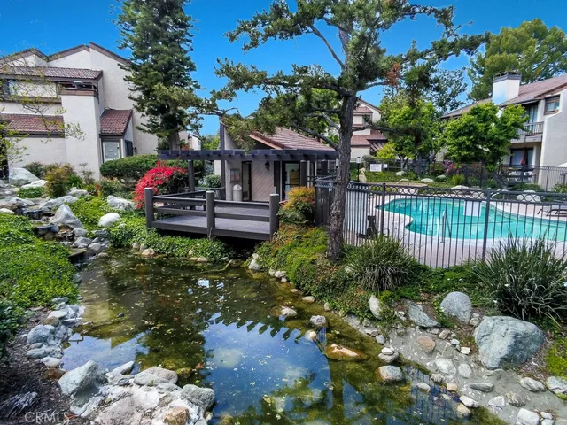a view of a house with a yard and garden