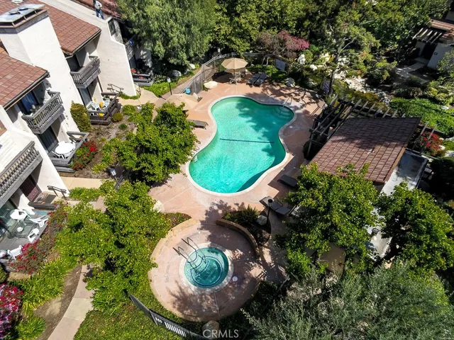an aerial view of a house with a yard and outdoor seating