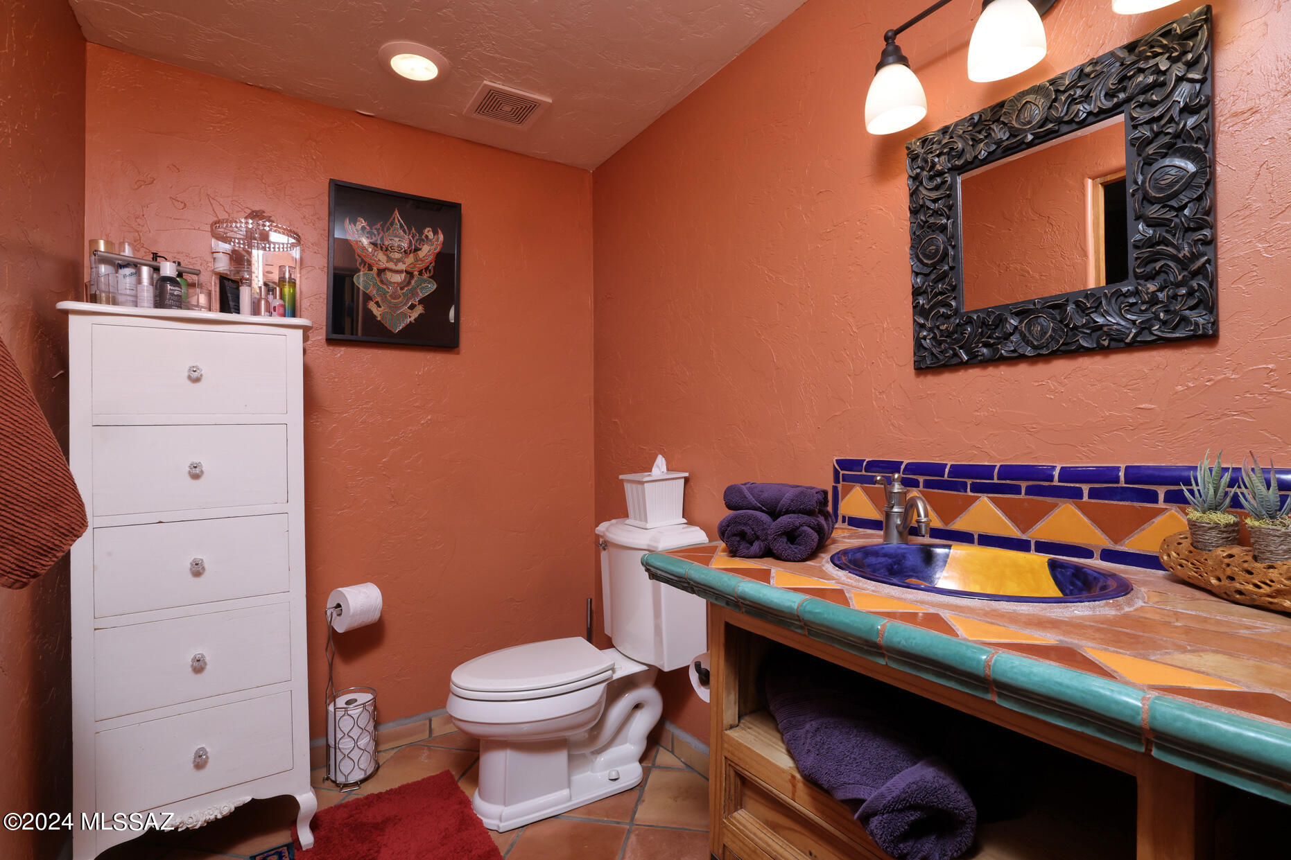 11725 East Spanish Ridge Place Tucson, AZ 85730 - Photo 34 of 51 a bathroom with a toilet sink and mirror