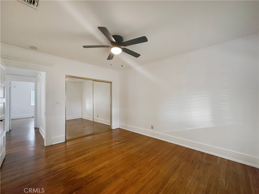209 Elm Street Alhambra, CA 91801 - Photo 11 of 17 an empty room with wooden floor a ceiling fan and closet